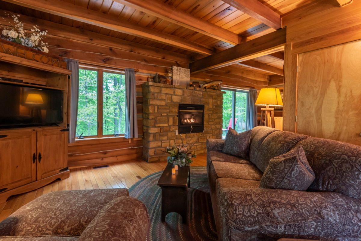 brown sofa on right of image with fireplace against wall to left