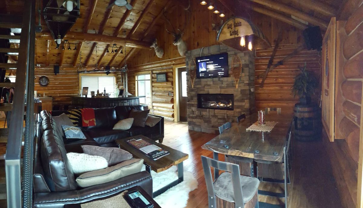 fireplace on wall with table on right and chairs on left