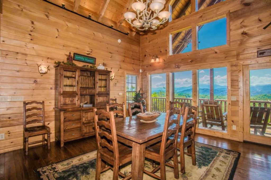 dining table with hutch on wall to left and windows in background