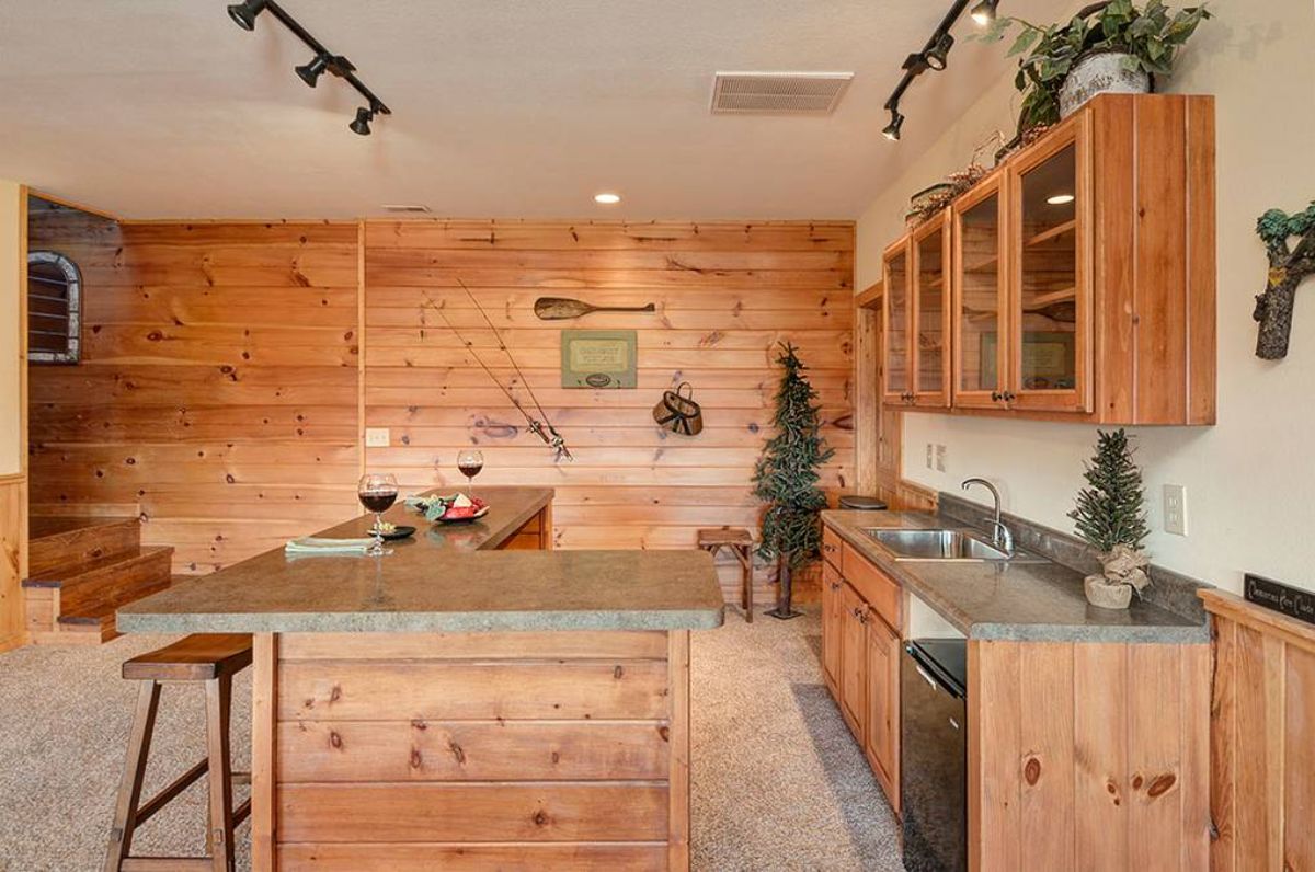 basement wet bar with light granite countertop