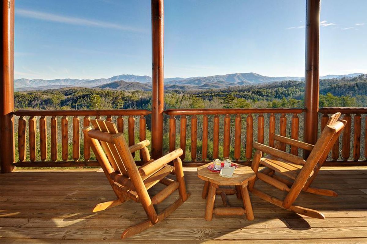 wooden chairs on deck with small table between them