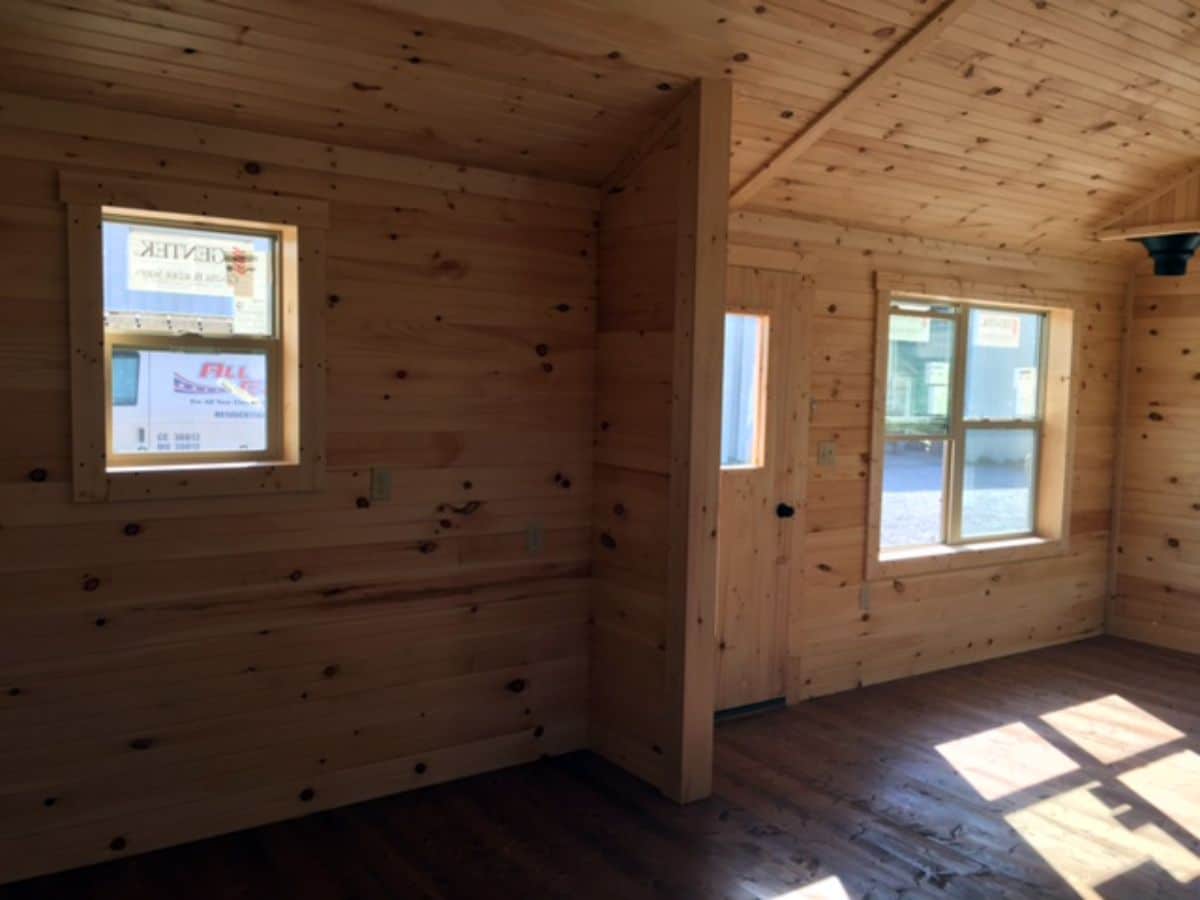 windows in side log cabin with light wood walls