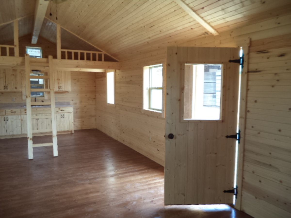 door into log cabin open with loft in background