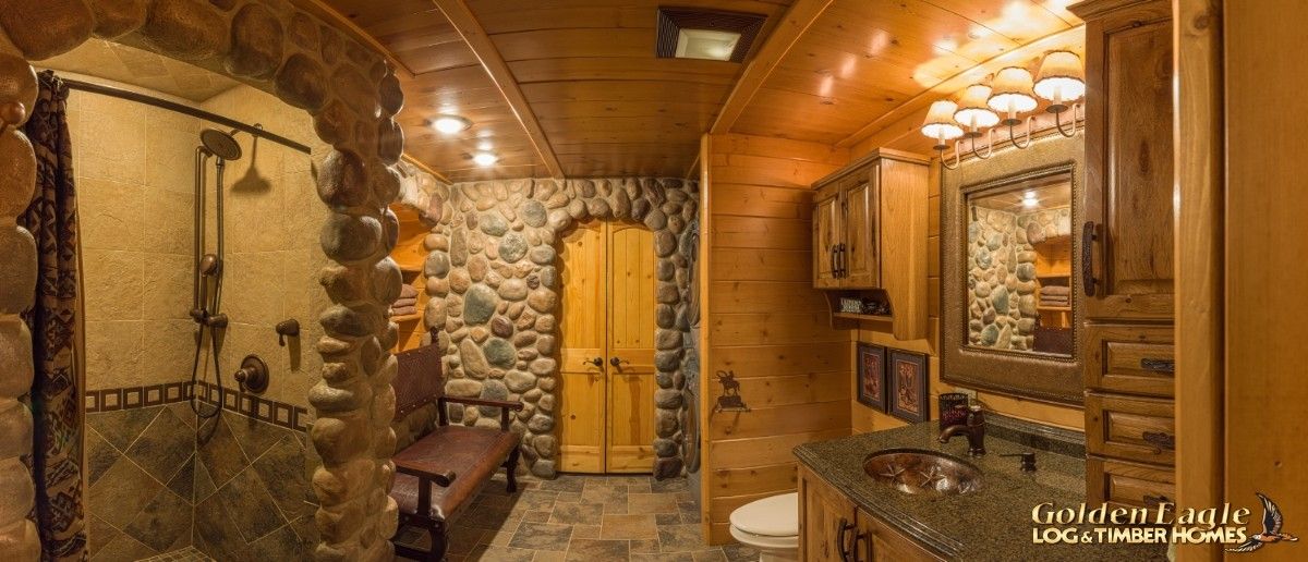 arched doorway at back of room with stone and log accents