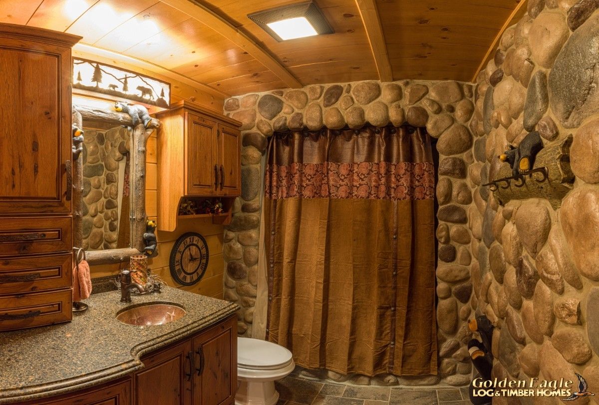 stone wall in bathroom with shower at back