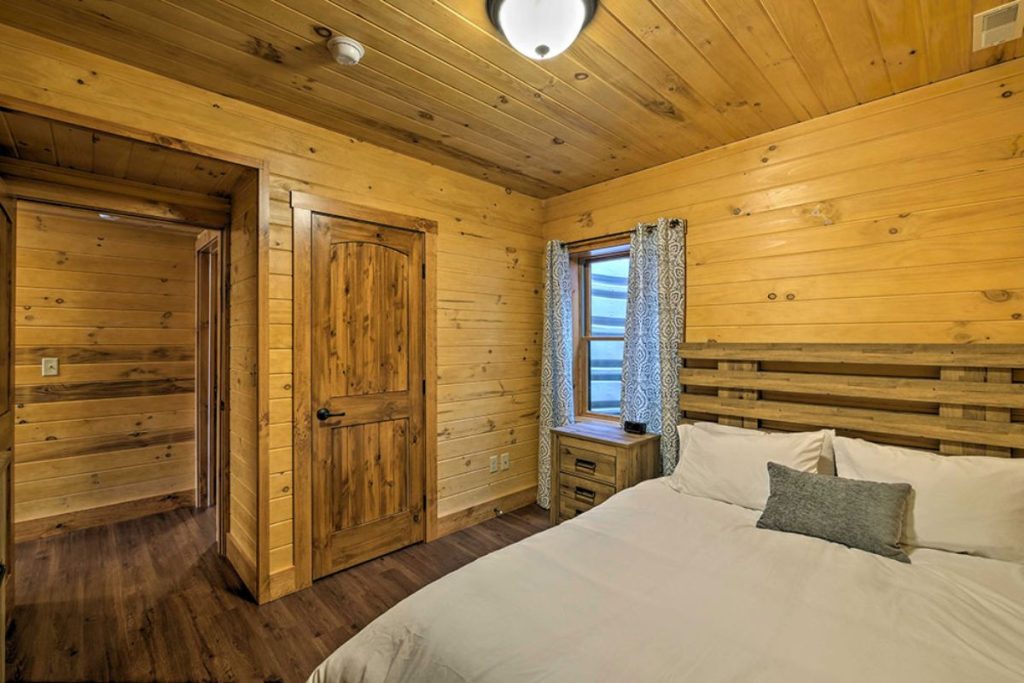closet door open on left of log cabin bedroom