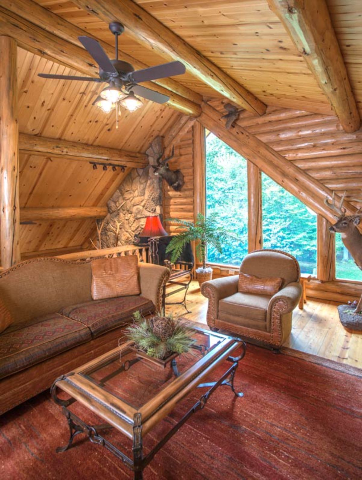 chair in front of trapezoid windows against log cabin wall