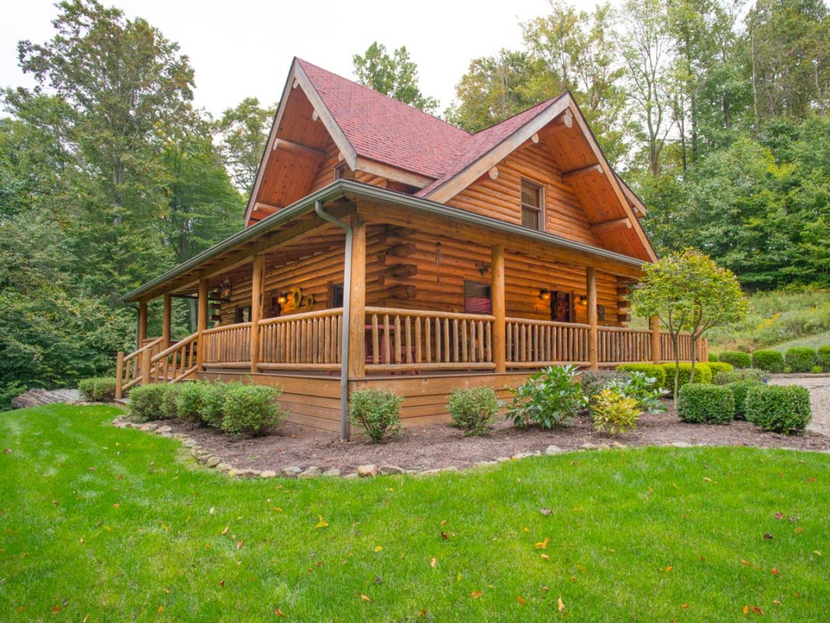 side of log cabin with covered porches