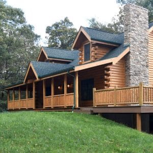 black roof on log cabin with covered front porch