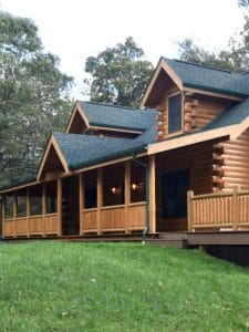 black roof on log cabin with covered front porch