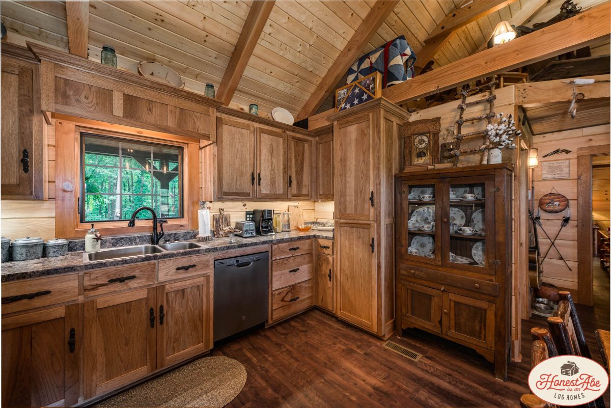 hutch on right side of image showing kitchen in log cabin