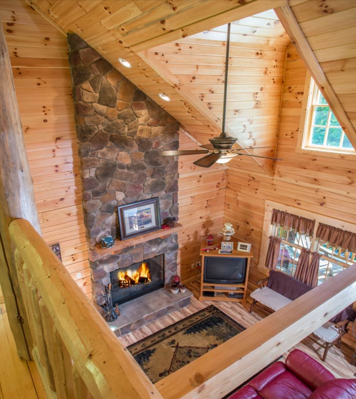 view from loft looking into the main floor of the log cabin