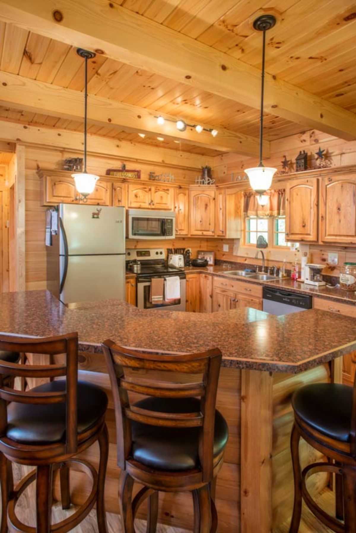 brown countertop above cabinet island in kitchen