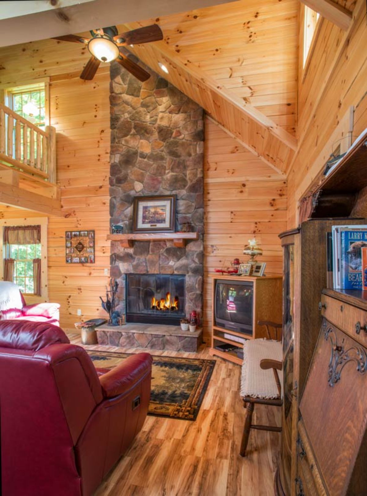 stone fireplace with red sofa in front