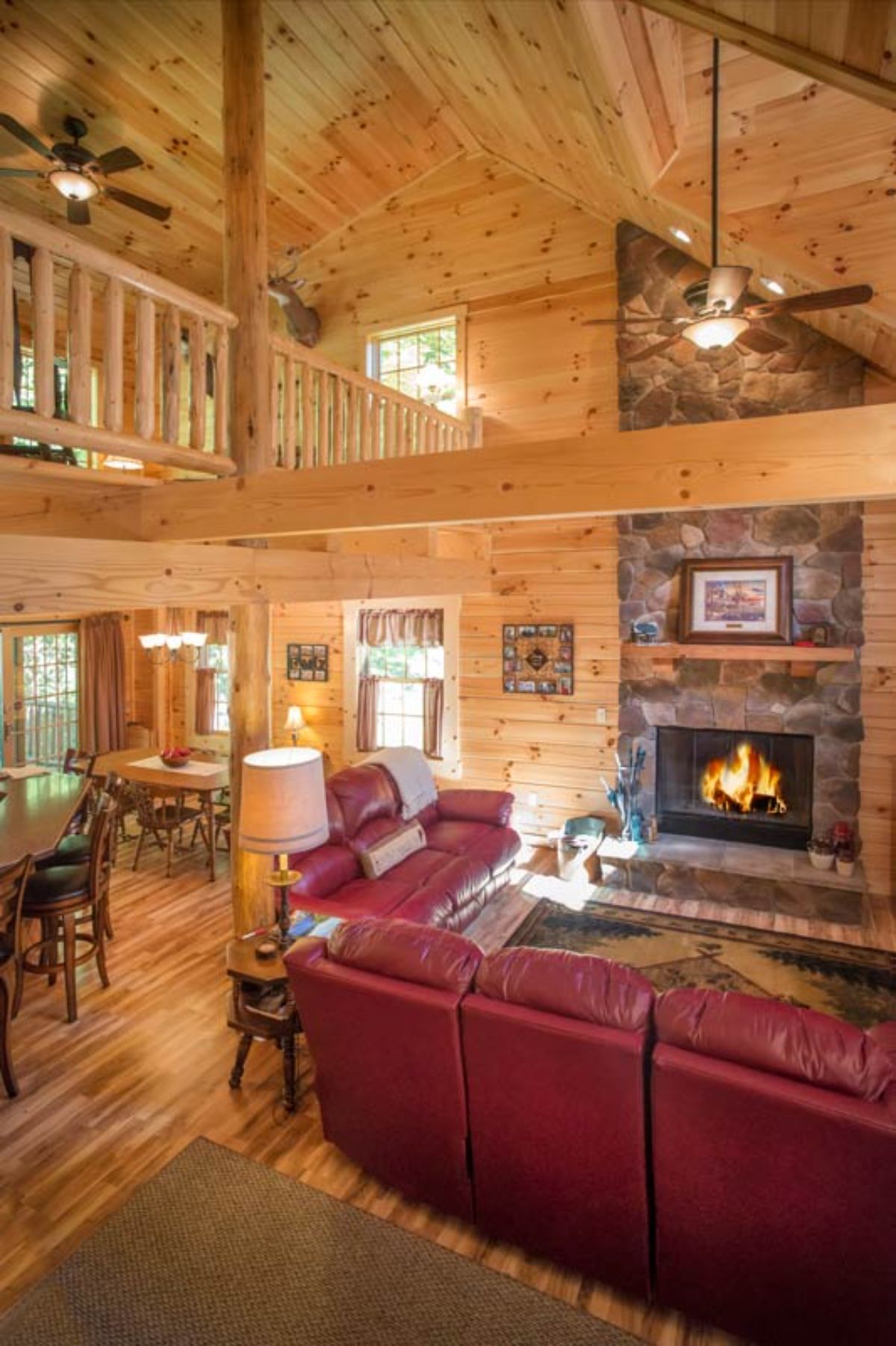 loft showing above sofas in main floor of log cabin on left