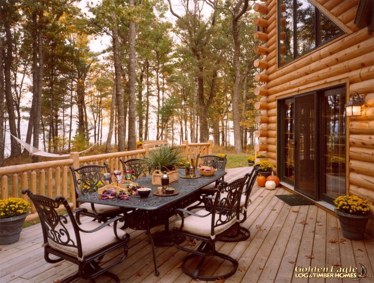 table on deck of log cabin by great room windows