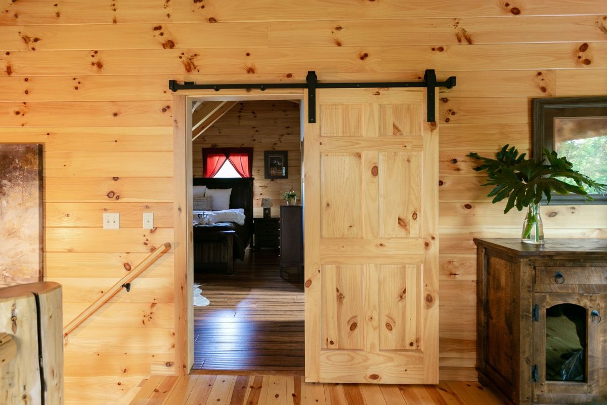 light wood barn door closer on loft bedroom