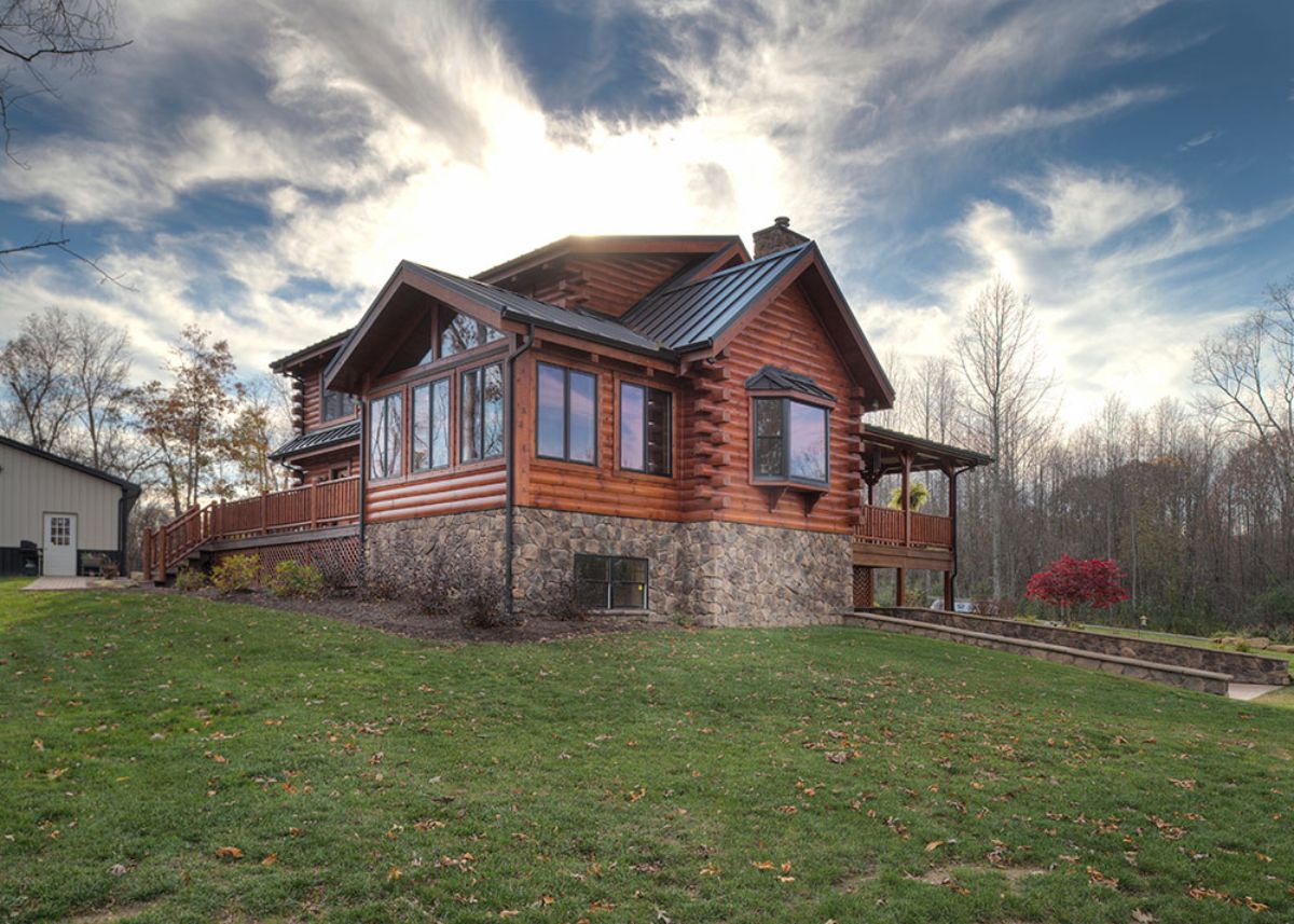 side of log cabin with stone foundation