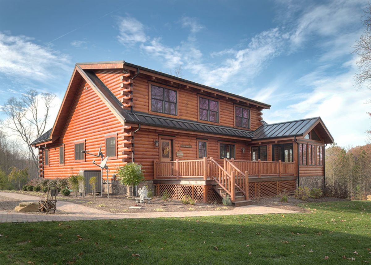 back of log cabin with uncovered porch on back