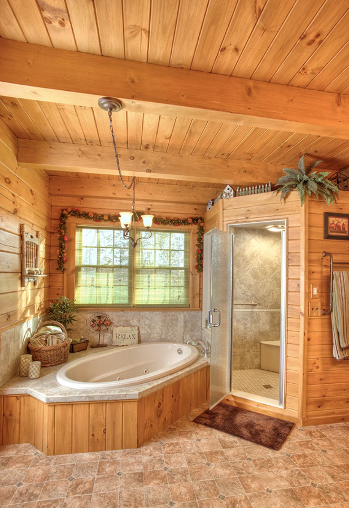 white soaking bathtub with tile behind tub and in shower of log cabin bathroom