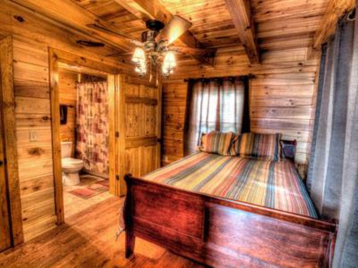 dark wood bed frame in log cabin bedroom