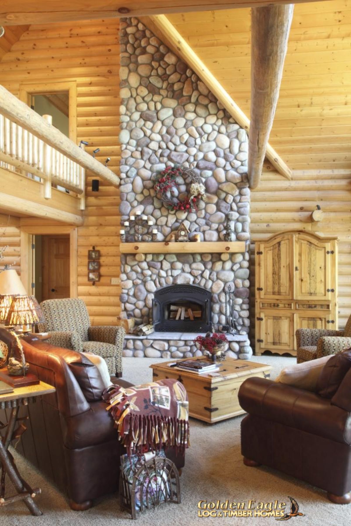 fireplace with stone against light wood cabin wall