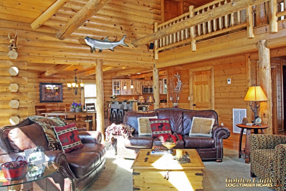 log cabin living room with sectional brown leather sofa underneath loft