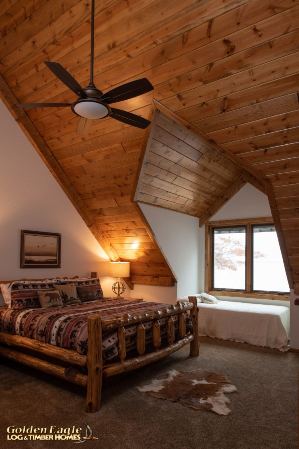 bed against white wall in log cabin dormer window bedroom