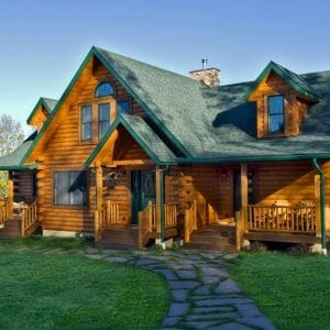 green metal roof on log cabin with two porches on front
