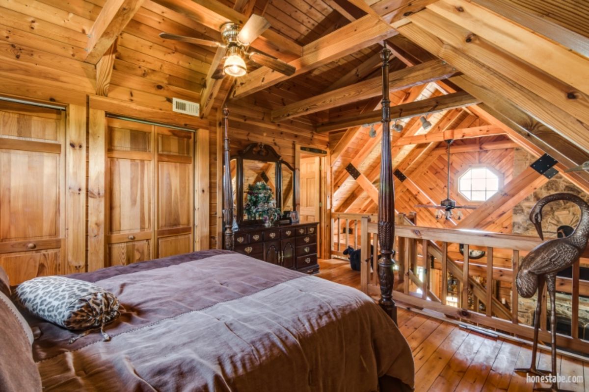 four poster bed in loft of log cabin