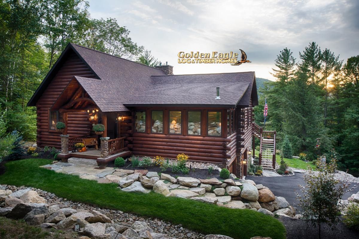 dark wood log cabin in rock landscaping