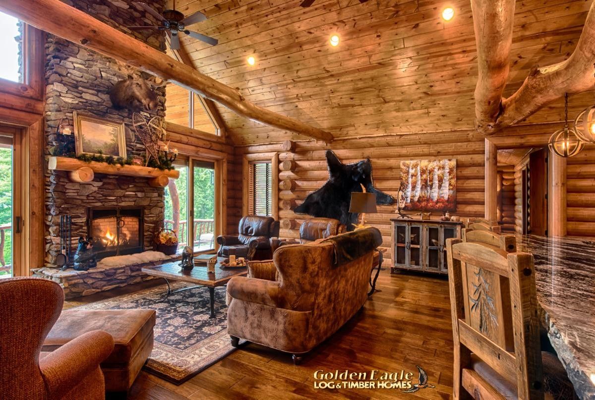 stone fireplace against left wall of windows with sofa in front