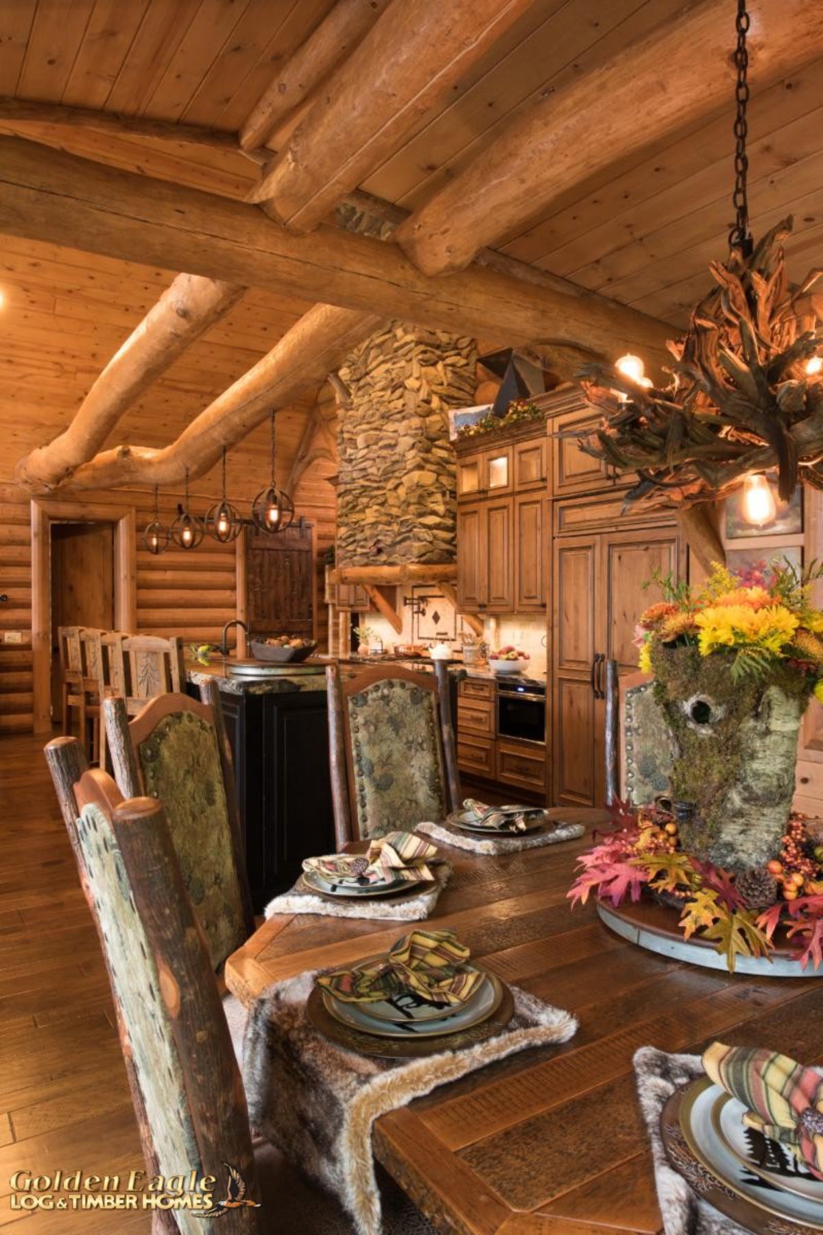 cloth upholstered chairs around round table in log cabin