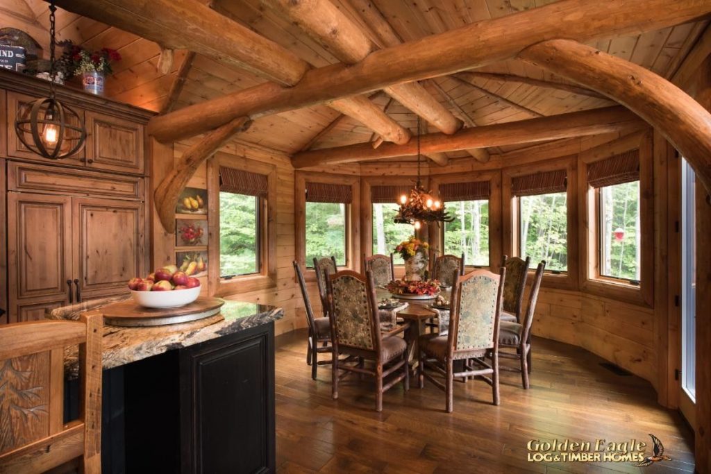 dining nook against wall of windows with kitchen in foreground