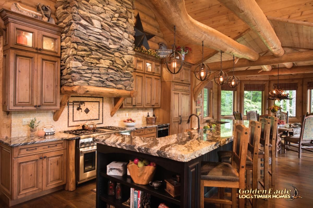 black cabinet island in kitchen with stone above stove