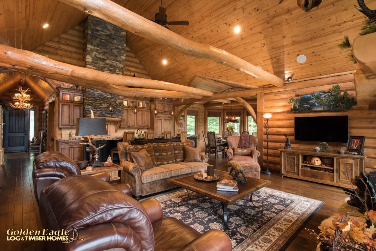 brown leather sofa in front of tv in log cabin living room