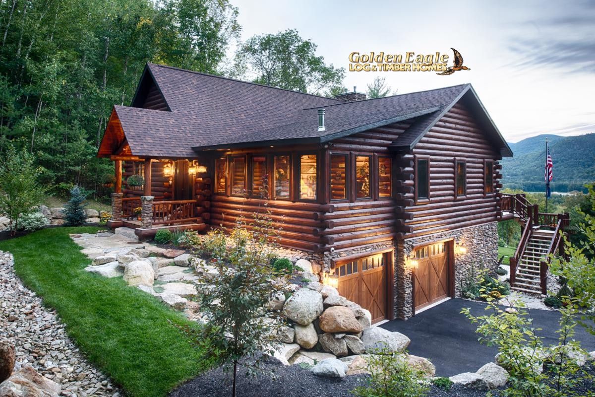 side of log cabin with a two car garage below on right