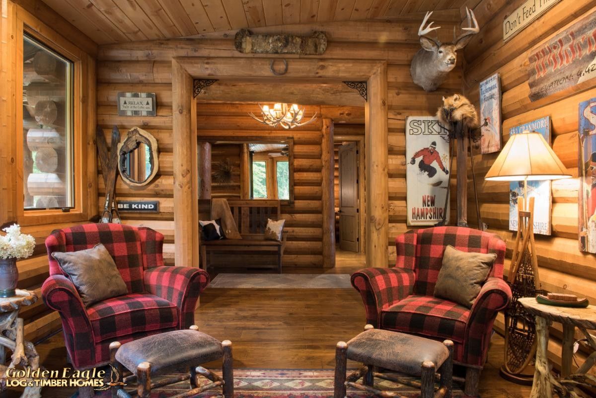 view into log cabin from red wing back chairs in sun room