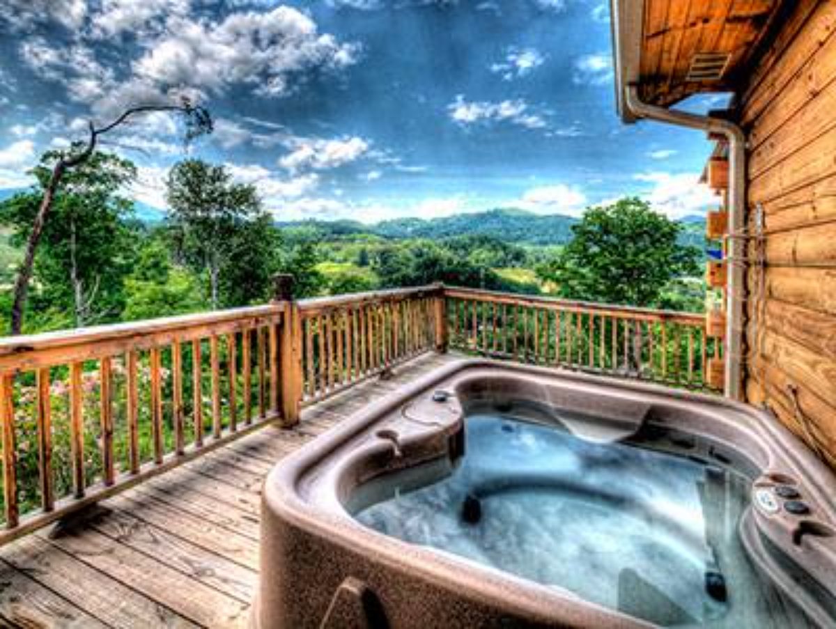 hot tub on deck of log cabin