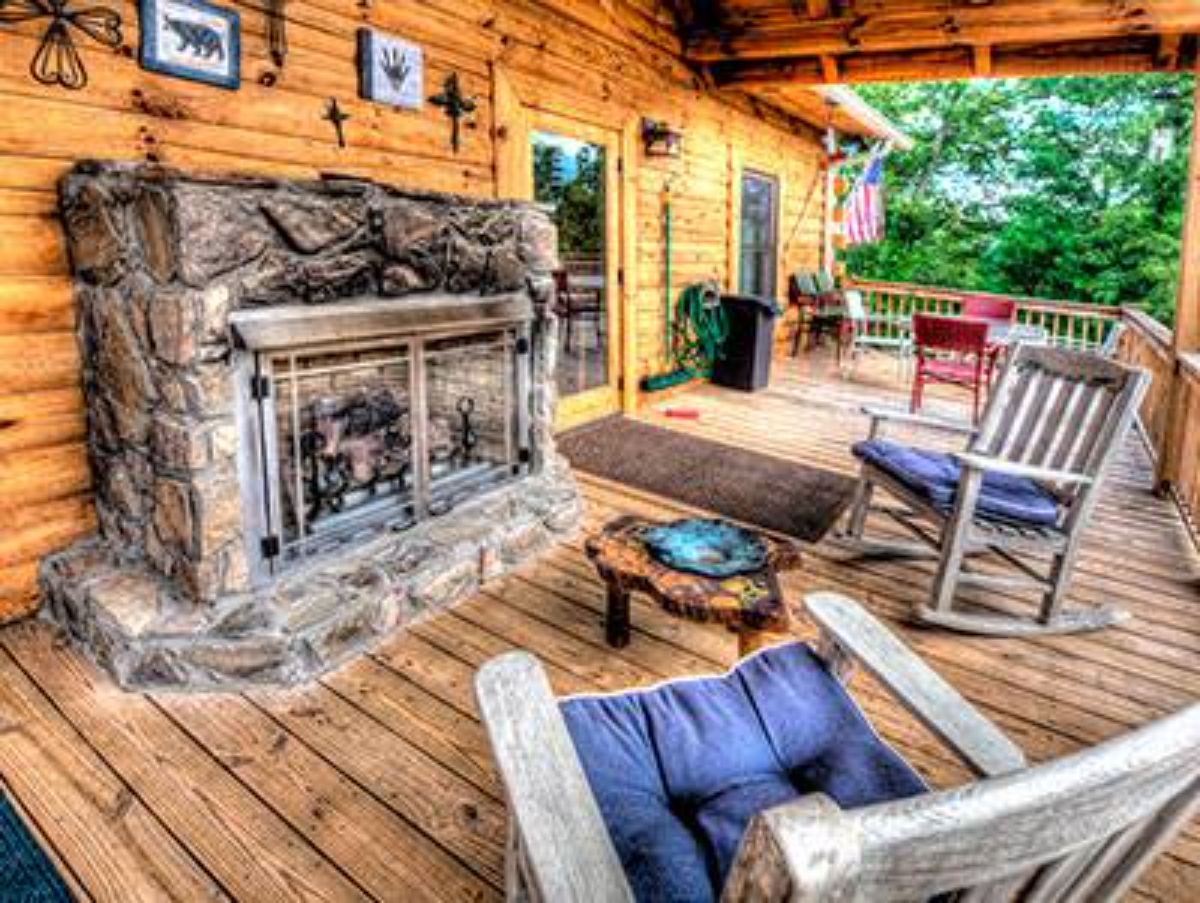 stone fireplace against wall with rocking chairs in front