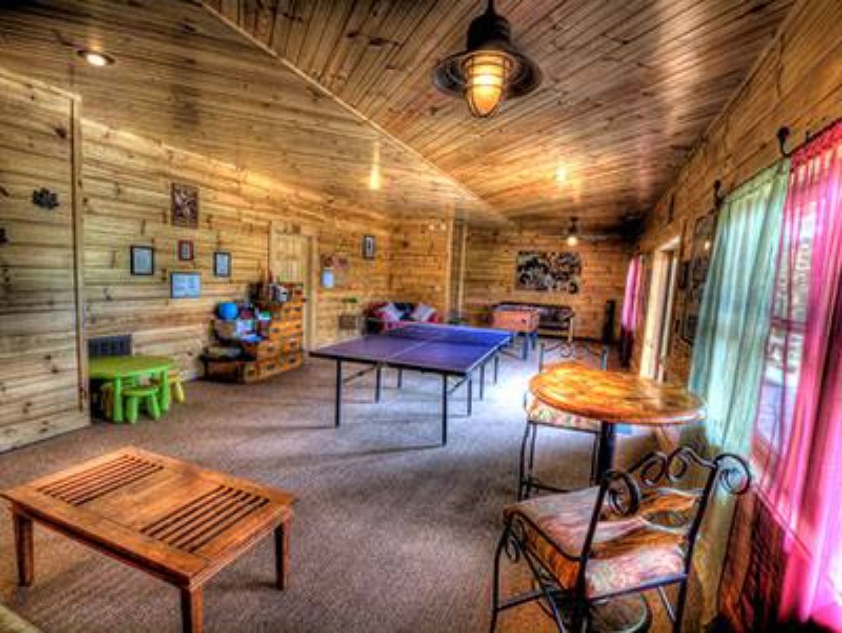 game room in cabin with wood table by rocking chair