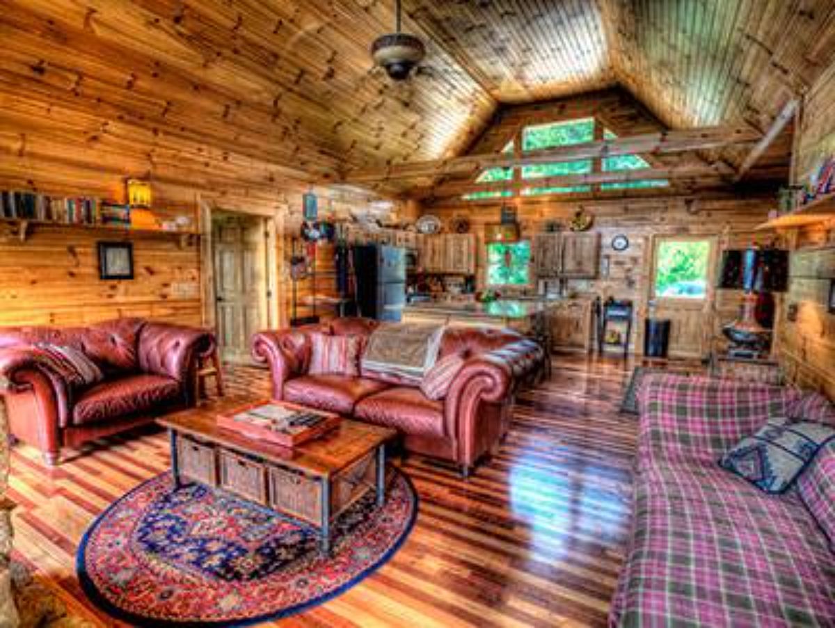 living room with red sofa on right wall and red leather loveseat on left wall