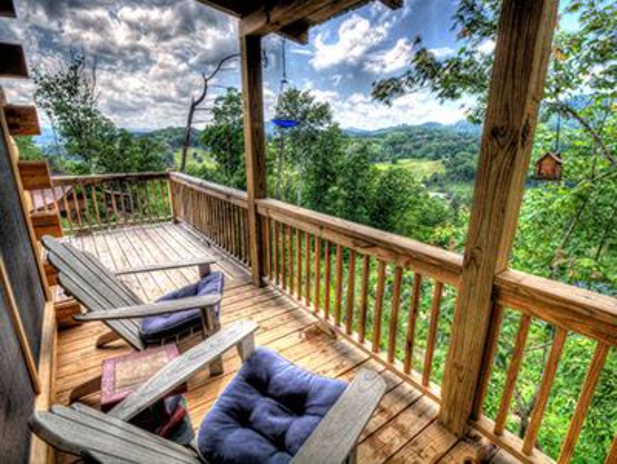 covered deck with white Adirondack chairs