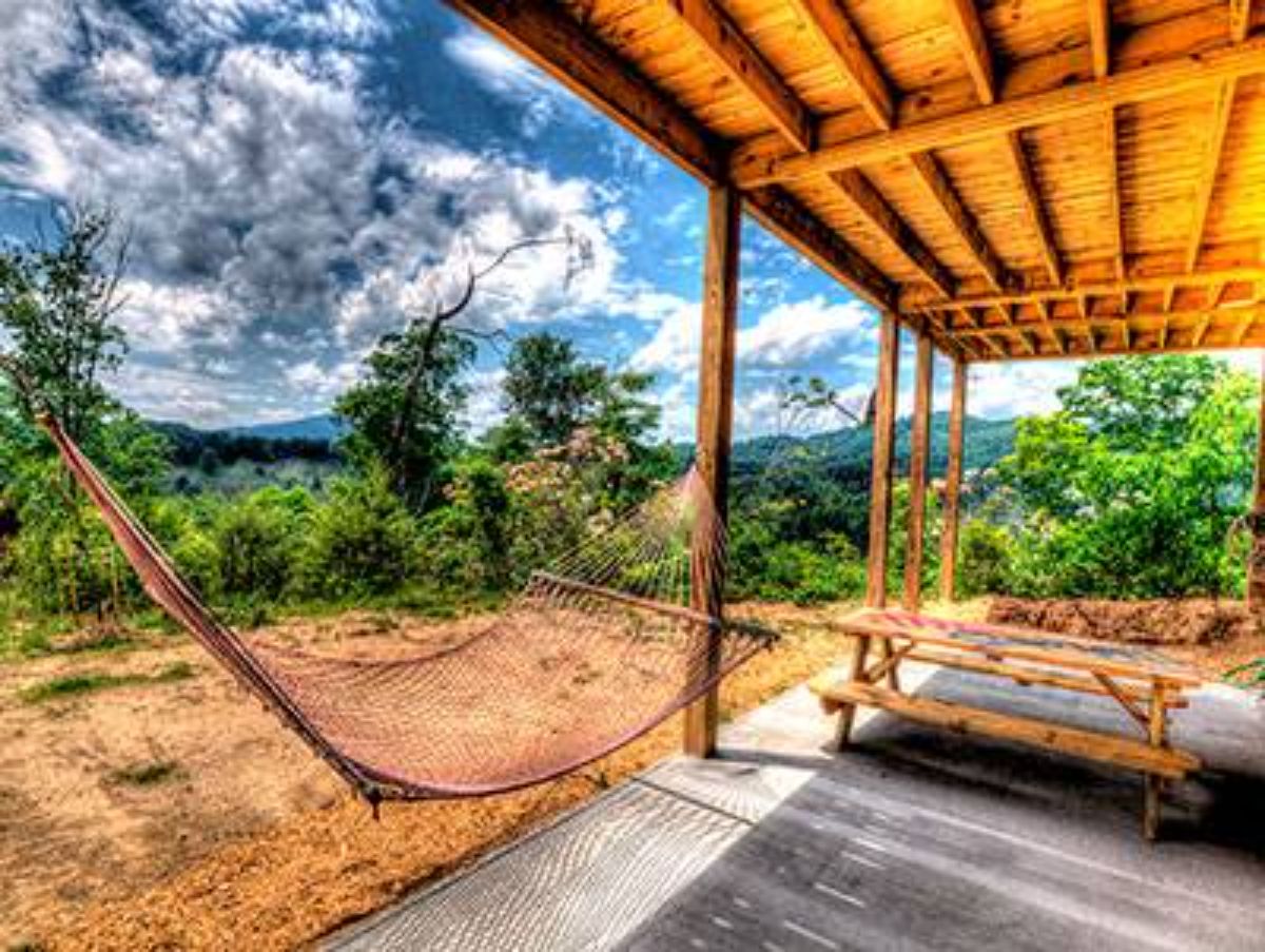porch swing below cover on log cabin deck