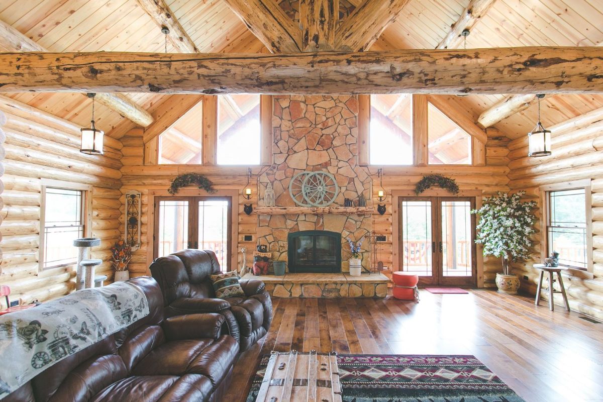 view directly to the stone fireplace on log cabin great room wall