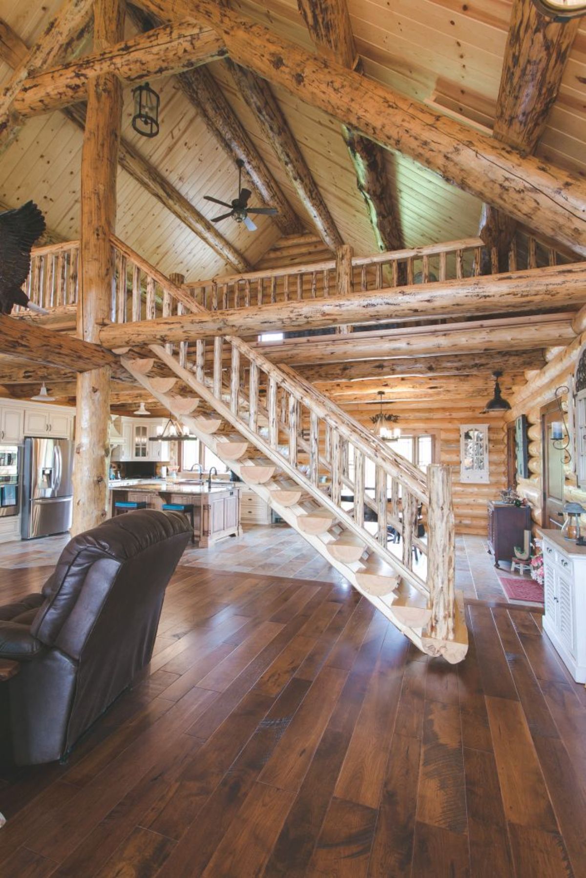 log stairs to loft with kitchen below loft