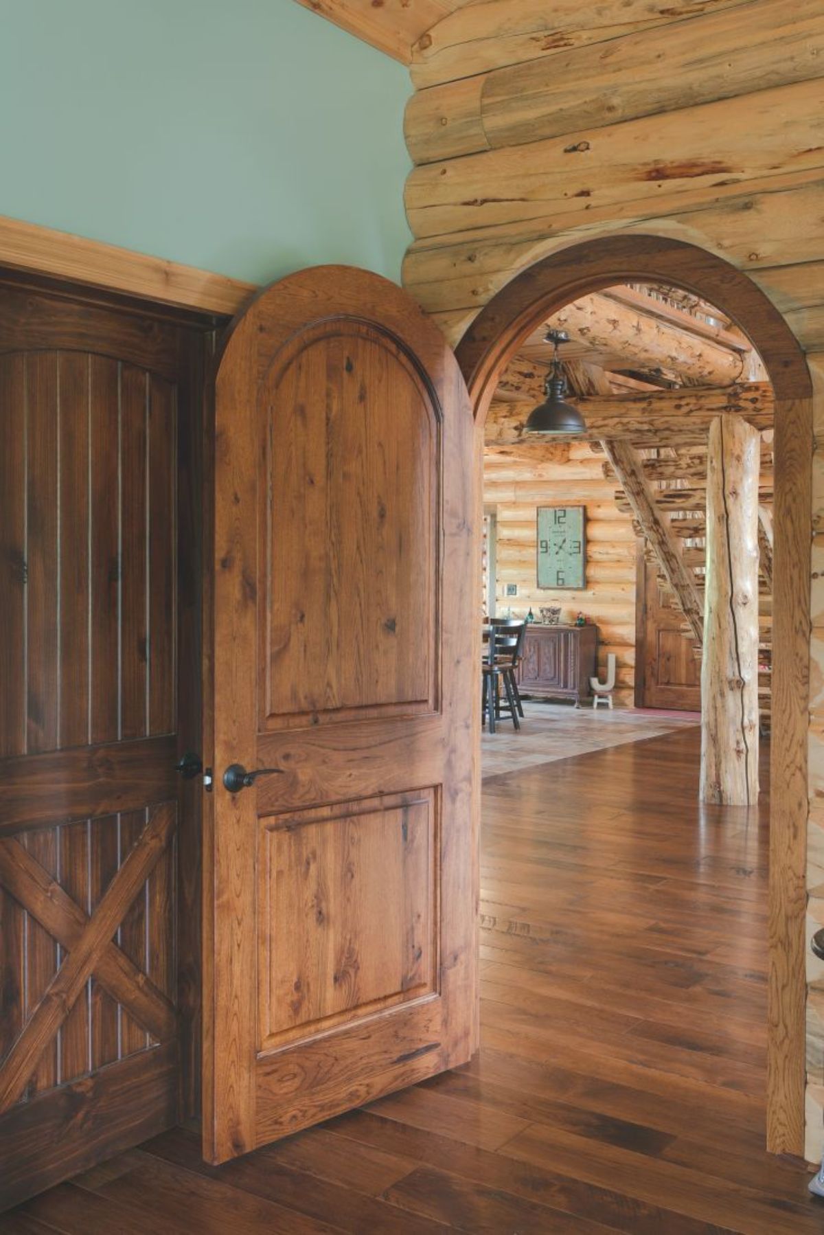 arched door open in bedroom looking out to main living space