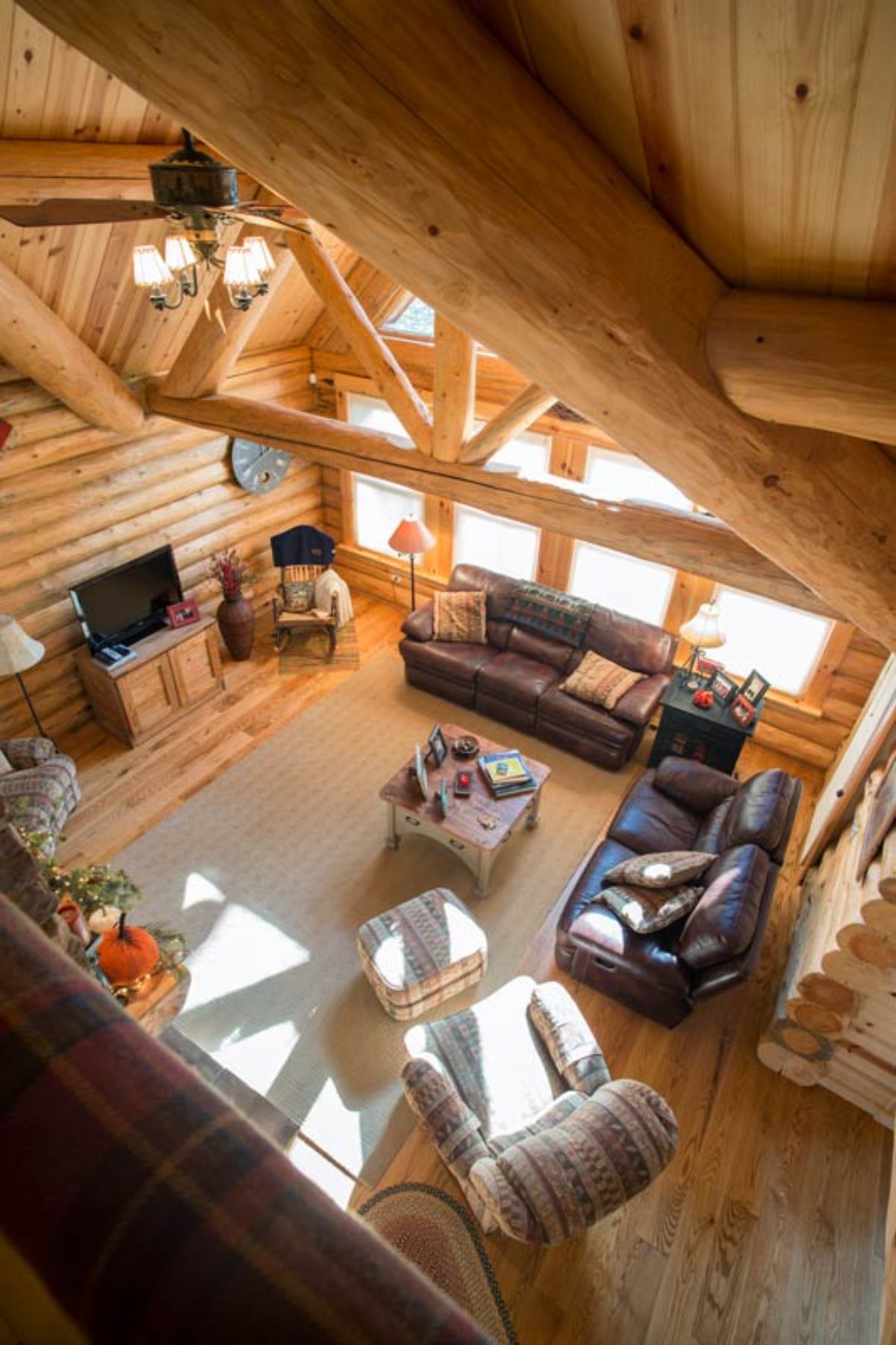 view down into great room from loft of log cabin