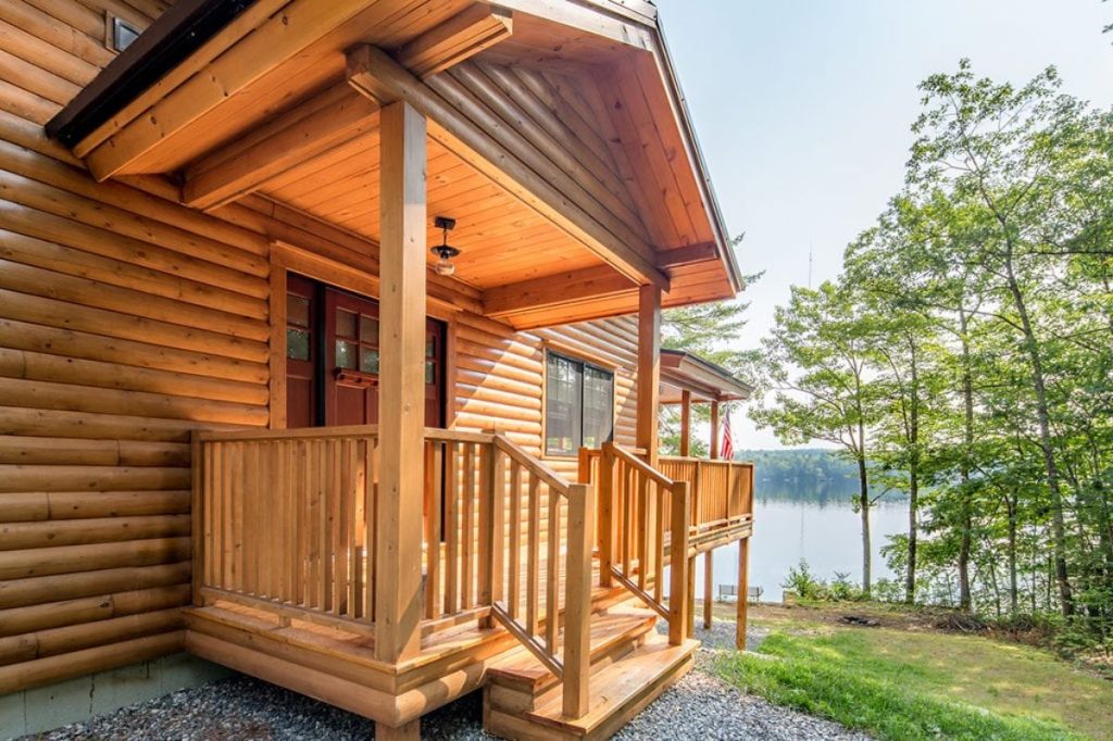 small porch on side of log cabin
