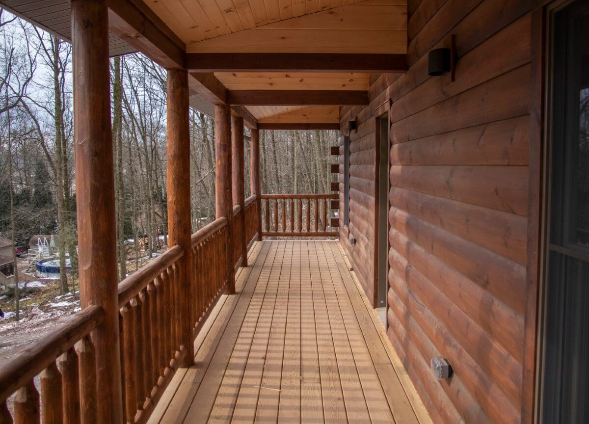 view under roof of covered deck on back of log cabin